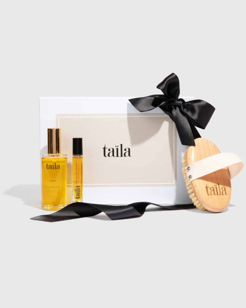 The taïla SAMA Body Set featuring KAYA Flora Body Oil, SCENT OF SHANTI Aroma Oil, and a Dry Brush on a white background.