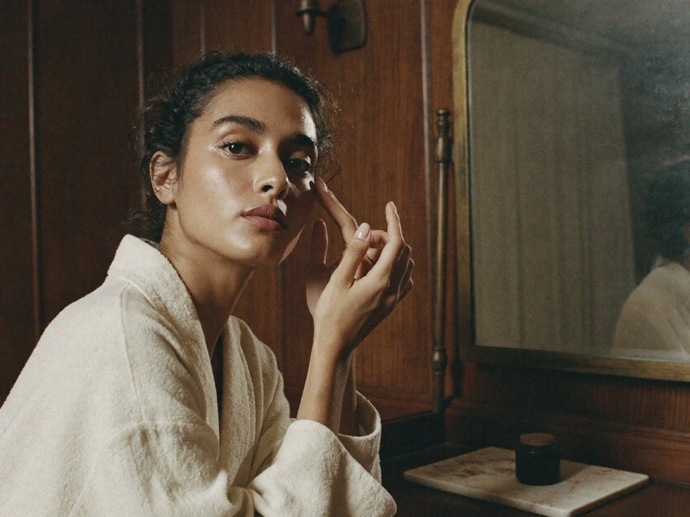 Woman touching her under eye in a bathrobe 