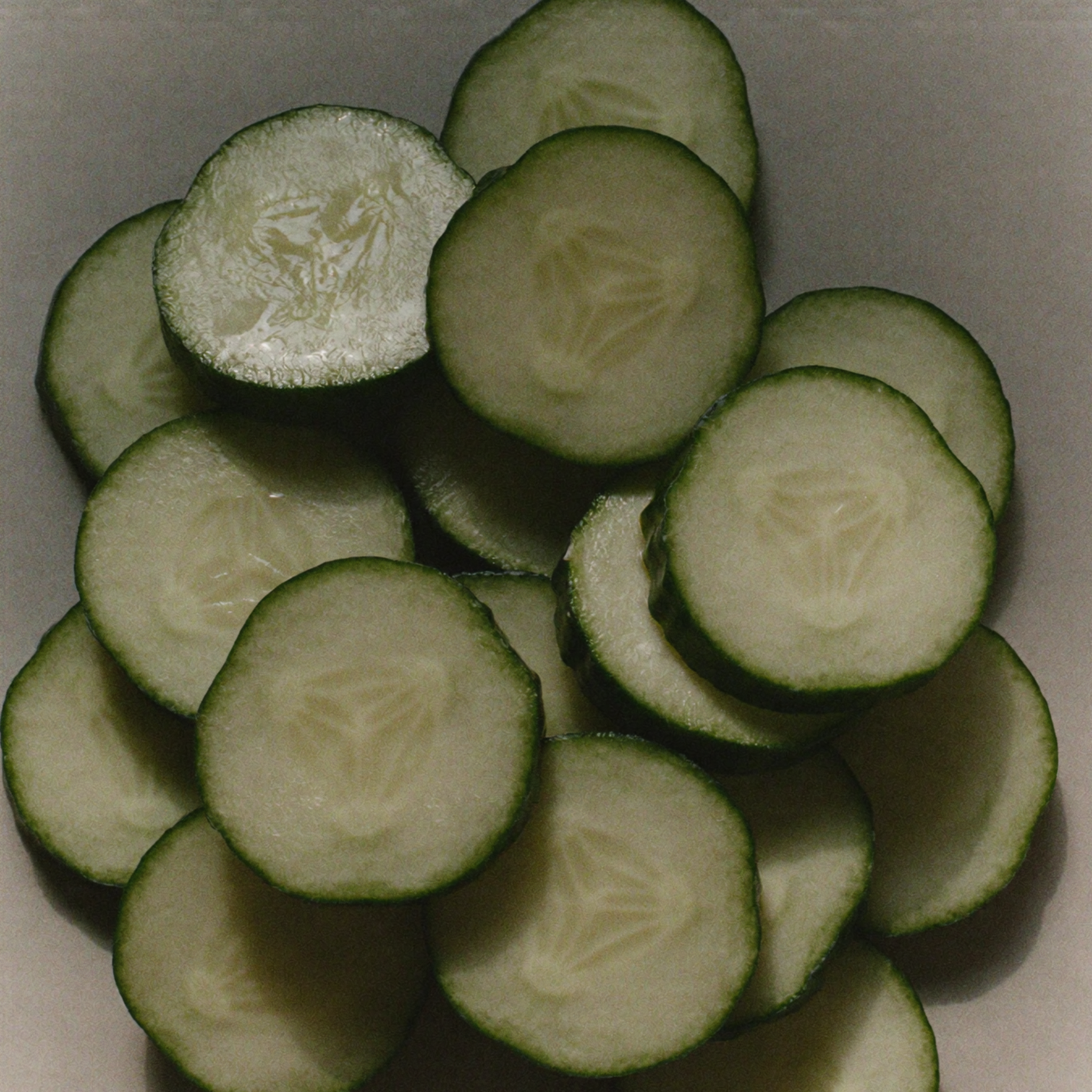 Fresh cucumber slices, a hydrating botanical skincare ingredient known for helping soothe visible redness and irritation.