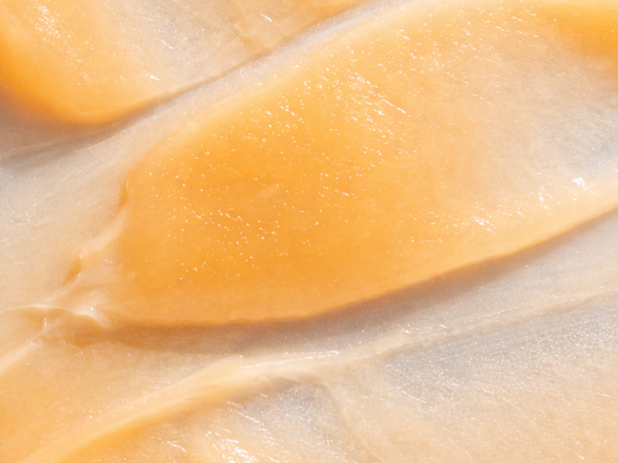 A precise close-up showing the rich, smooth, and concentrated texture of the restorative eye balm, highlighting the waterless, active-dense structure that supports enzymatic clarity.