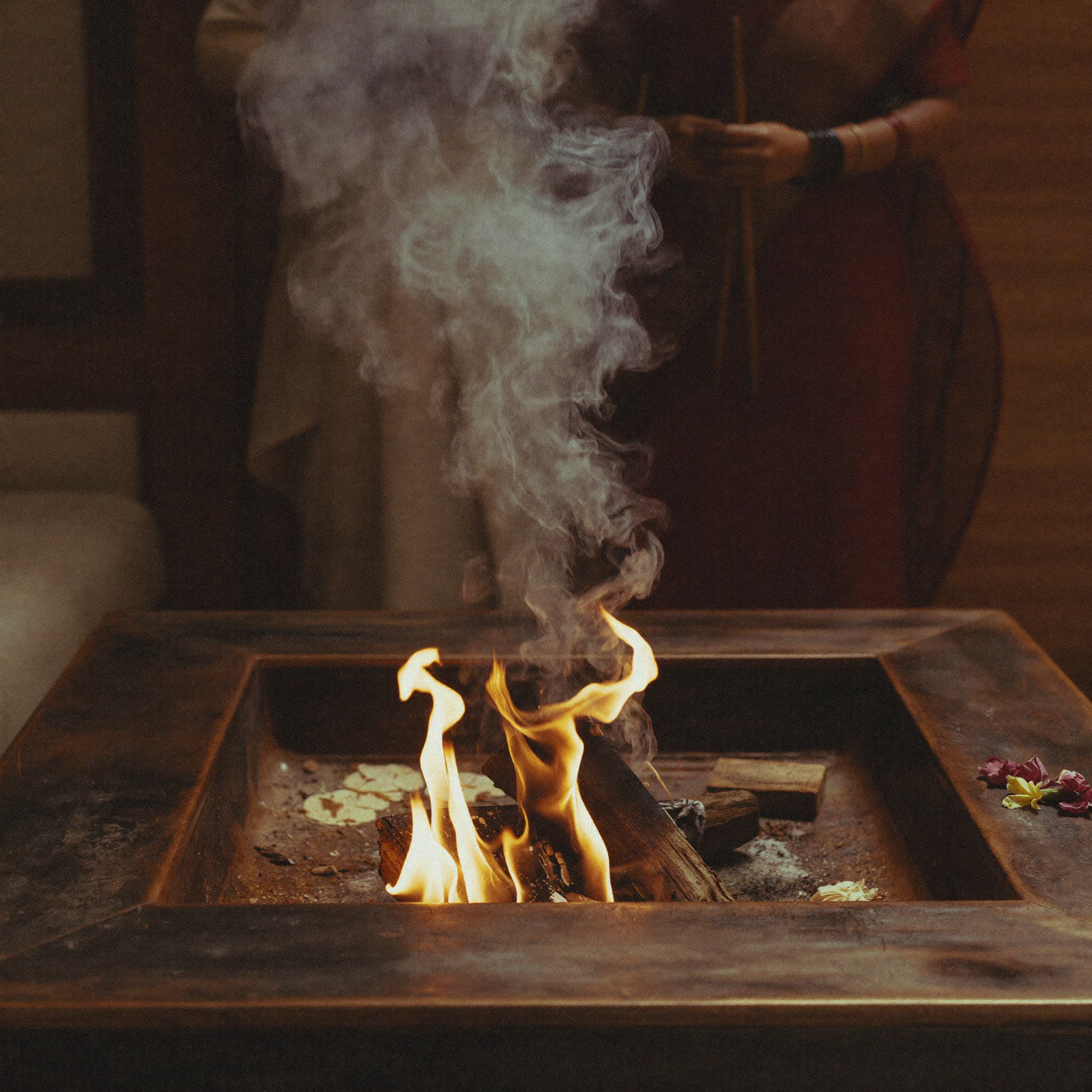 An ancient Hindu Vedic Yajna fire ritual with smoke rising from a brick altar during an aromatic purification ceremony.