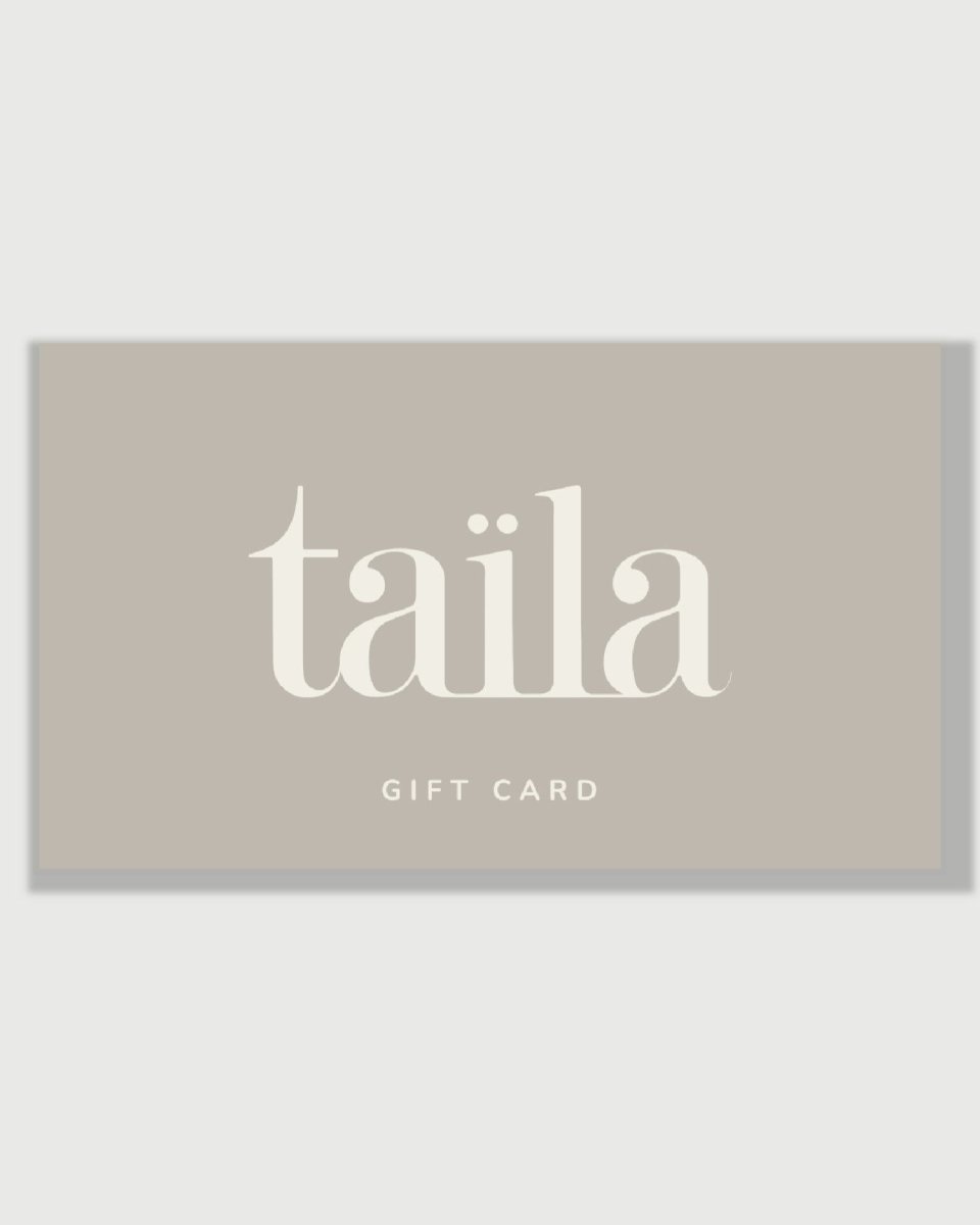 An elegant taïla luxury skincare digital gift card displayed against a minimalist warm gray background.
