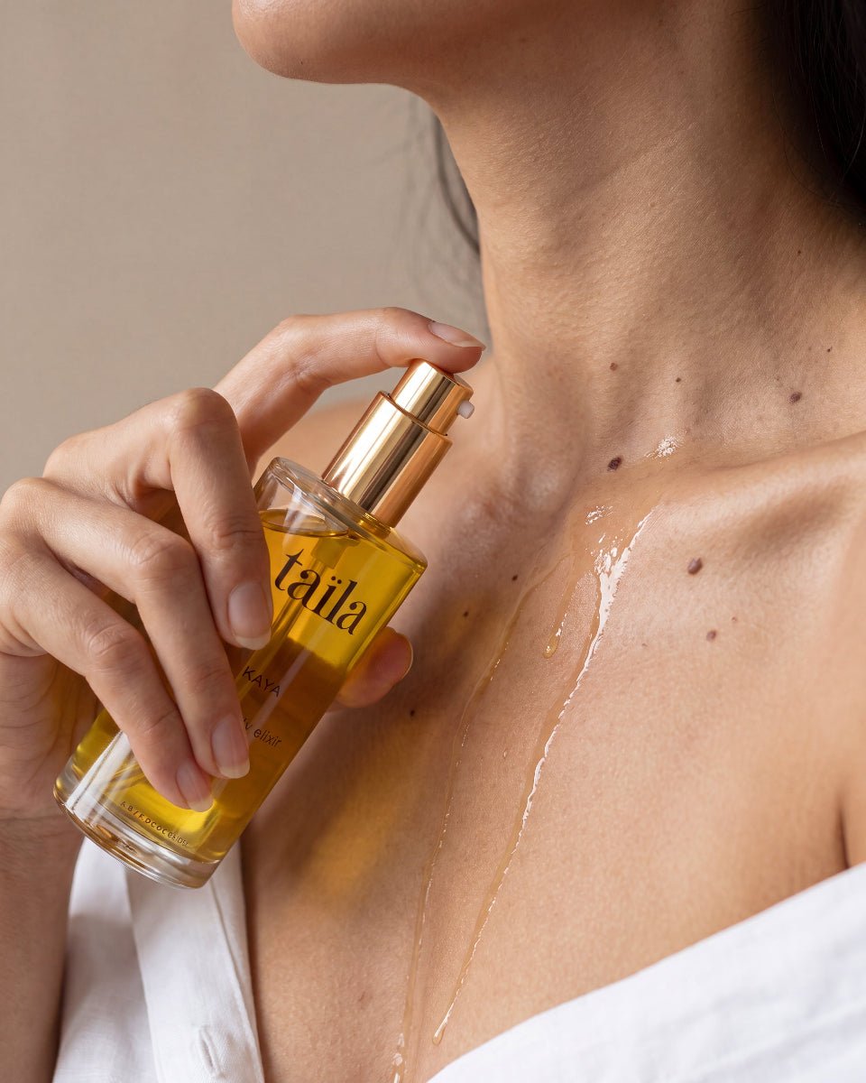 Hands massaging luxurious taila Kaya Flora Body Oil Elixir onto skin for natural moisture, improving skin firmness and help reducing the appearance of cellulite with Ayurvedic botanicals.
